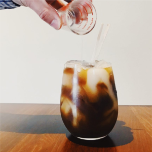 Photograph of the cocktail 'Hazelnut Nigori Iced Coffee'